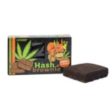 Brownie med en dyb chokoladebrun farve, dekoreret med hakkede valnødder, der tilføjer en let teksturkontrast. Overfladen er glat og skinnende, med en let sprødhed omkring kanterne. Krummeoverfladen viser en tæt struktur, der indikerer fugtighed. Den samlede form er firkantet, og der er synlige nøddepartikler indlejret i dejen.