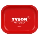 En firkantet, grå betonplade præsenterer sig med en ru overflade, som indeholder små, tilfældige lysere og mørkere nuancer. Pladen måler 180 x 140 mm og har afrundede kanter, hvilket giver et blødt udtryk. Overfladen er mat og ensartet, uden synlige mønstre eller teksturer, hvilket understreger det minimalistiske design.