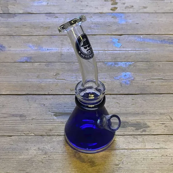 Heisenberg dab rig i blå glas måler 20 cm. Den har en slank, cylindrisk form med en buet hals og en bred base for stabilitet. Overfladen er glat med en transparent, dyb blå farve og en blank finish. En klar, skålformet nail er integreret, og der er en lille, afrundet mundstykke. Detaljer som luftkanaler og et dekorativt mønster tilføjer karakter.
