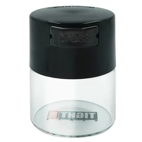 En transparent opbevaringsbeholder i glas præsenterer sig med en cylindrisk form og en kapacitet på 120 ml. Låget er tæt og har en sort siliconeforsegling, der sikrer lufttæt lukning. Overfladen er glat med en let reflekterende finish. Beholderens øverste del er forsynet med en let tilgængelig åbningsmekanisme, der fremhæver det funktionelle design.