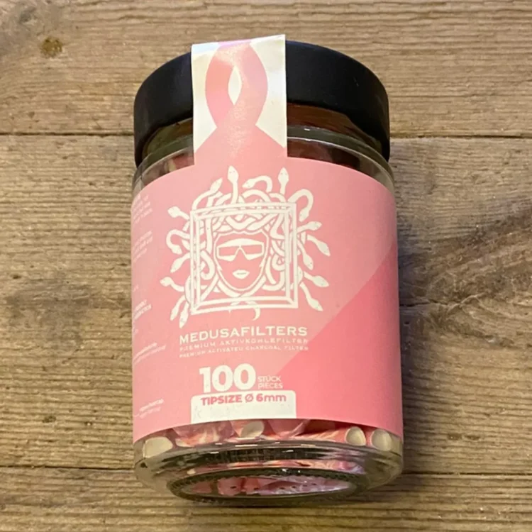 Medusa Filters Rosé Edition 100 stk Ø6 i klart glas med sort låg og lyserød etiket med hvidt hovedmotiv og "MEDUSAFILTERS".