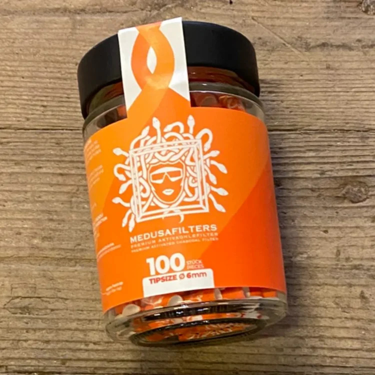 Medusa Filters Sunset Edition 100 stk Ø6 i klar beholder med orange etiket, hvidt Medusahoved og teksten "MEDUSAFILTERS".