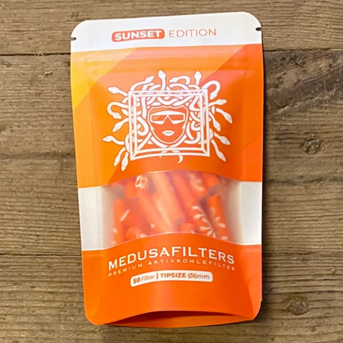 Medusa Filters Sunset Edition 50 stk Ø6 i orange pose med hvidt "MEDUSAFILTERS" og orange filtre vist på forsiden.