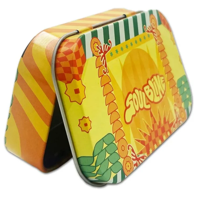 SOULBLIME 720 Metal Tin Yellow med orange striber på æsken og grønne blade omkring "SOULBLIME" på låget.